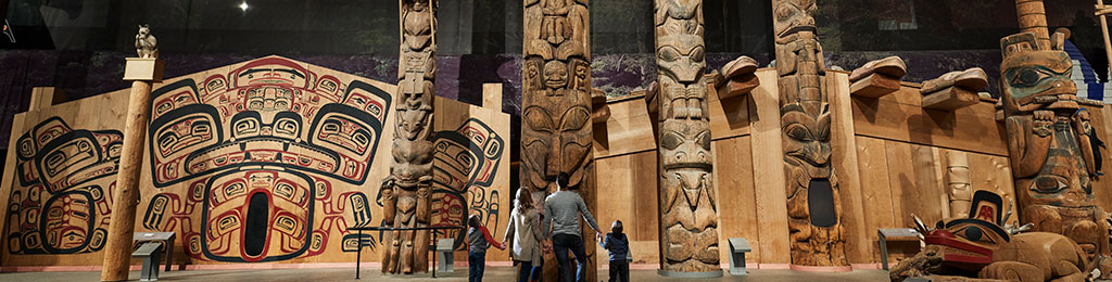 Photo of the Canadian Museum of History’s Grand Hall showing Indigenous art and artifacts, sculptures, and totem poles