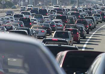 Photograph of many cars stuck in traffic on a multi-lane highway